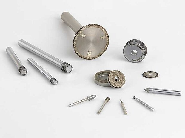 Diamond grinding pins with galvanic bonding